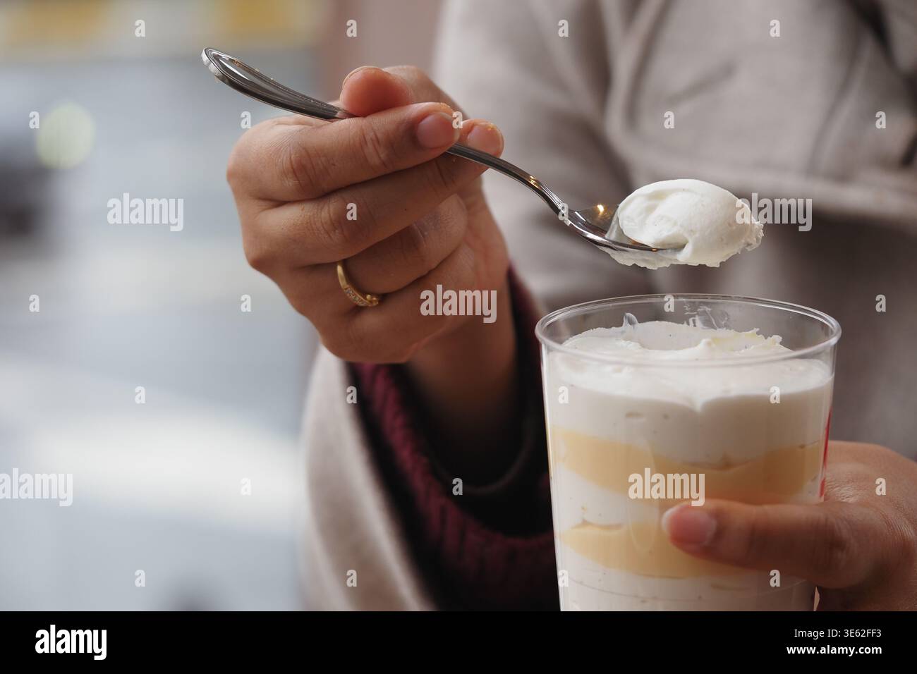 Genießen Sie ein Dessert mit Löffel in der Hand in einem Café Stockfoto
