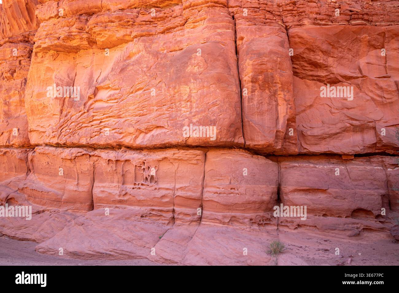 Die geschichtete rote Sandsteinwand entlang der Shafer Canyon Road, Utah, zeigt Erosionsmuster und natürliche Wüstenfelsen. Stockfoto