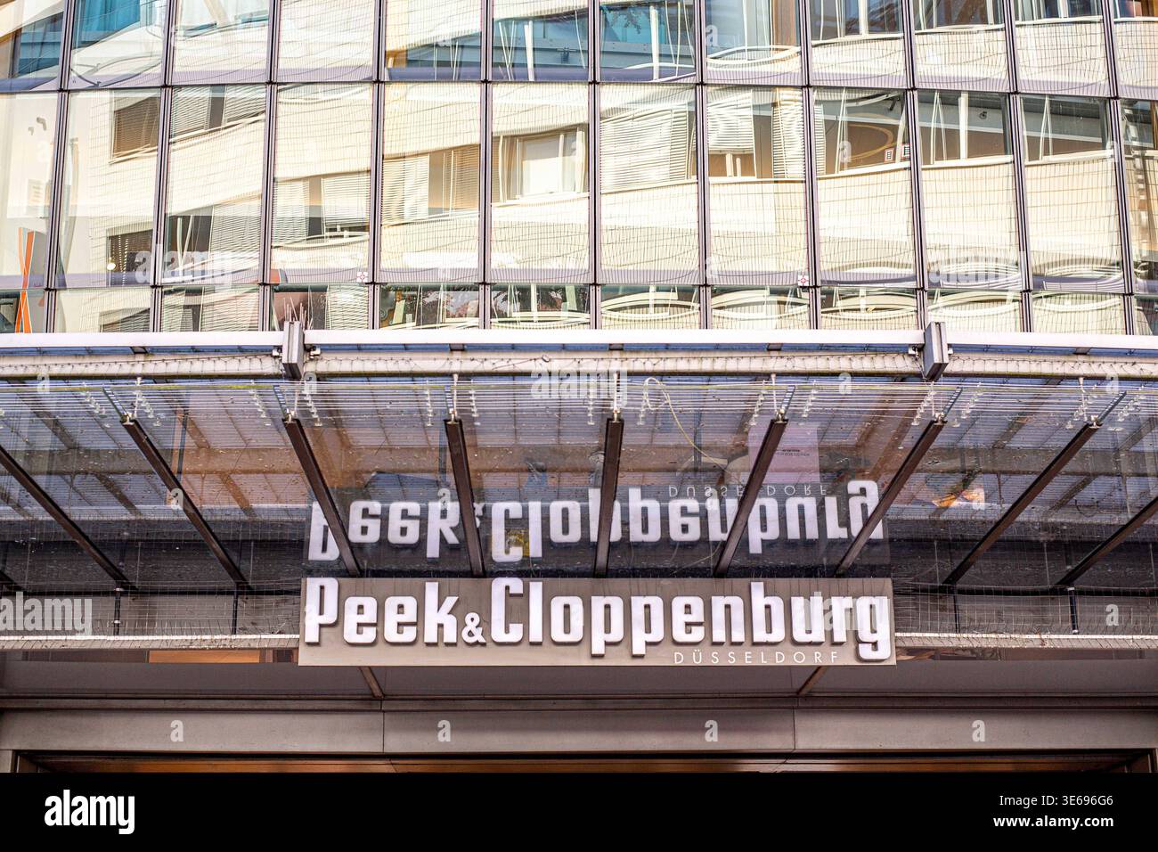 Das Bild zeigt den Eingangsbereich einer Filiale von Peek & Cloppenburg. Bei dem markanten Gebäude mit der geschwungenen Glasfassade handelt es sich um das von Renzo Piano entworfene Weltstadthaus in Köln an der Schildergasse. P&C *** das Bild zeigt den Eingangsbereich eines Peek Cloppenburg Stores das markante Gebäude mit der geschwungenen Glasfassade ist das von Renzo Piano in Köln entworfene Weltstadthaus an der Schildergasse P C Stockfoto