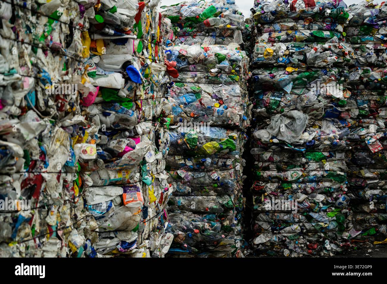 In einer Recyclinganlage hoch gestapelte komprimierte Ballen von Kunststoffflaschen Stockfoto