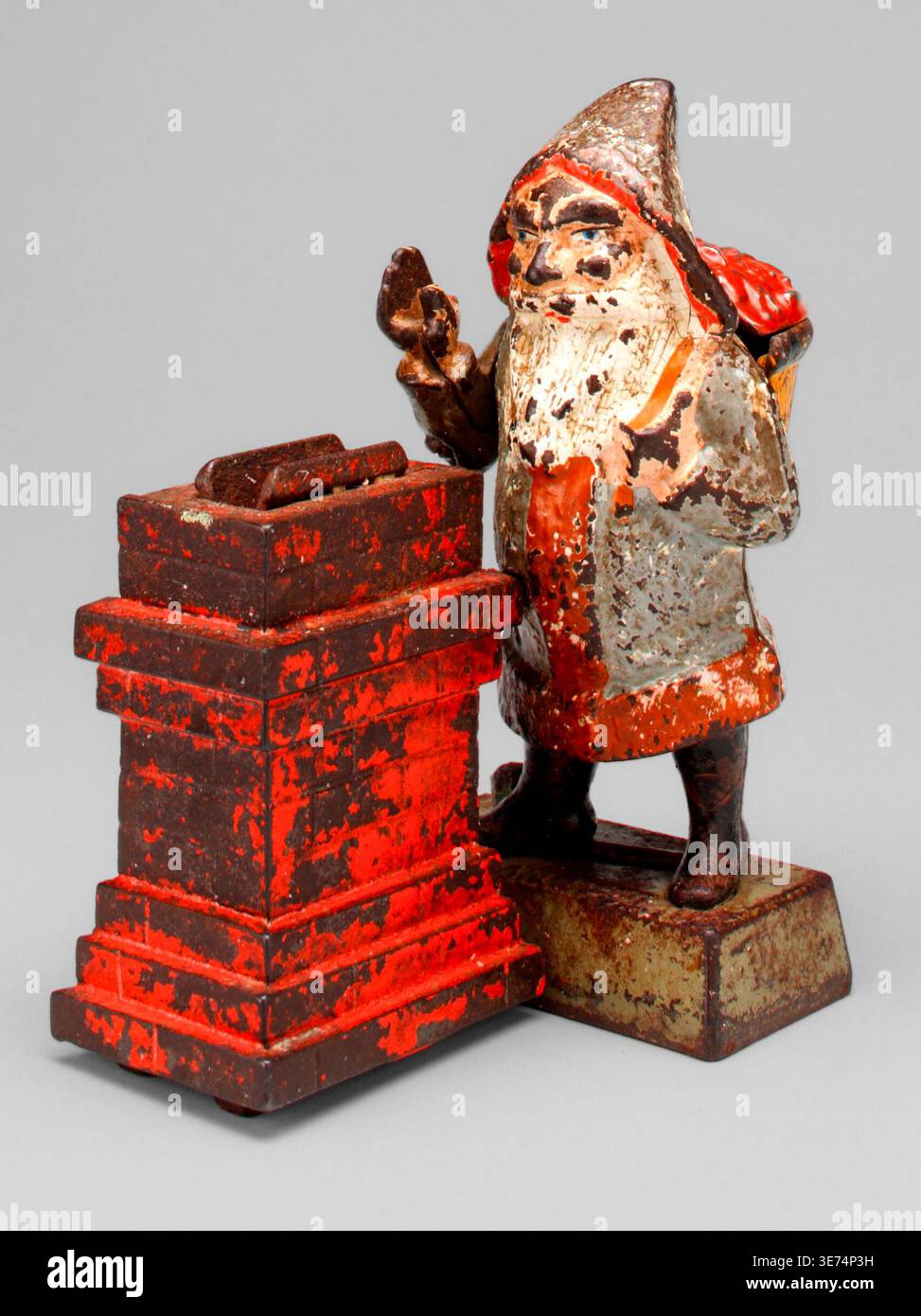Santa Claus mechanische Bank, entworfen von Peter Adams und Charles G. Shepard für Shepard Hardware Company, um 1889. Das bemalte gusseiserne Objekt zeigt den Weihnachtsmann neben einem gestuften Ziegelkamin. Stockfoto