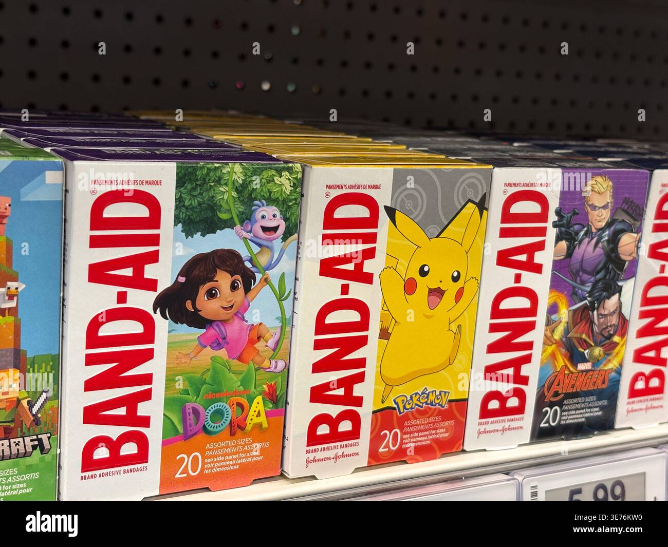 In einer Apotheke sind Schachteln mit Pflasterbinden mit den Charakteren Dora the Explorer, Pokemon und Marvel Avengers ausgestellt. Stockfoto