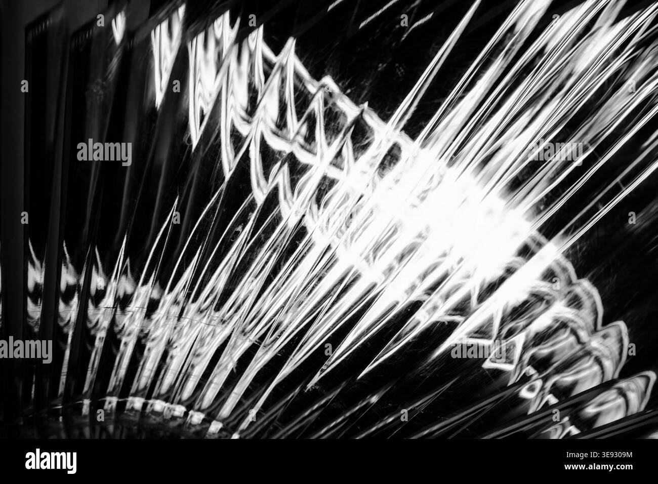 Abstrakte, kontrastreiche Schwarzweiß-Lichtstrahlen und Glasbrechung Stockfoto