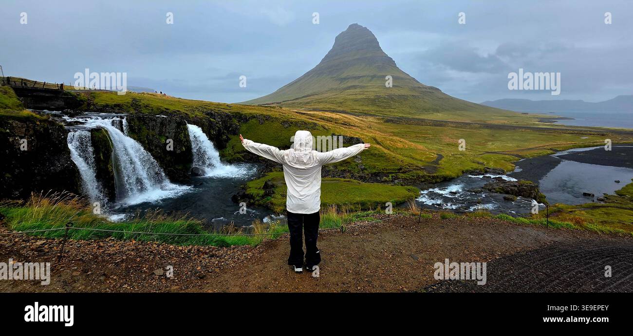 Frau, die den Berg Kirkjufell beobachtet - Smartphone-aufgenommenes Stockfoto