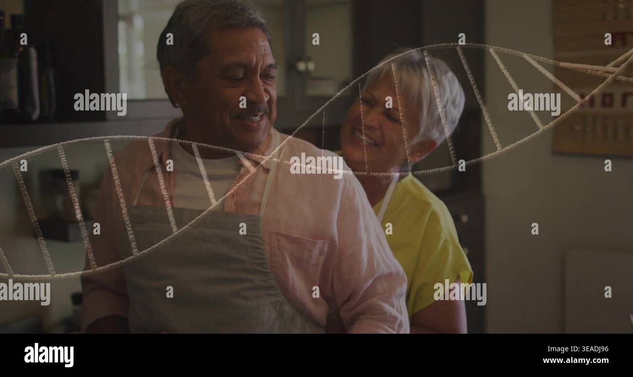 Stehendes Seniorenpaar, das in der Küche kocht, Schürzen in der Nähe von Holzschränken und DNA-Overlay trägt Stockfoto