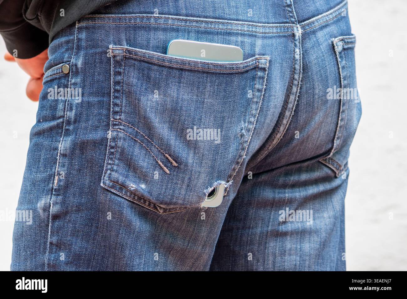 Die Kleidungsdetails mit dem Telefon zeigen den täglichen Gebrauch und das Risiko des Geräteverlusts. Stockfoto