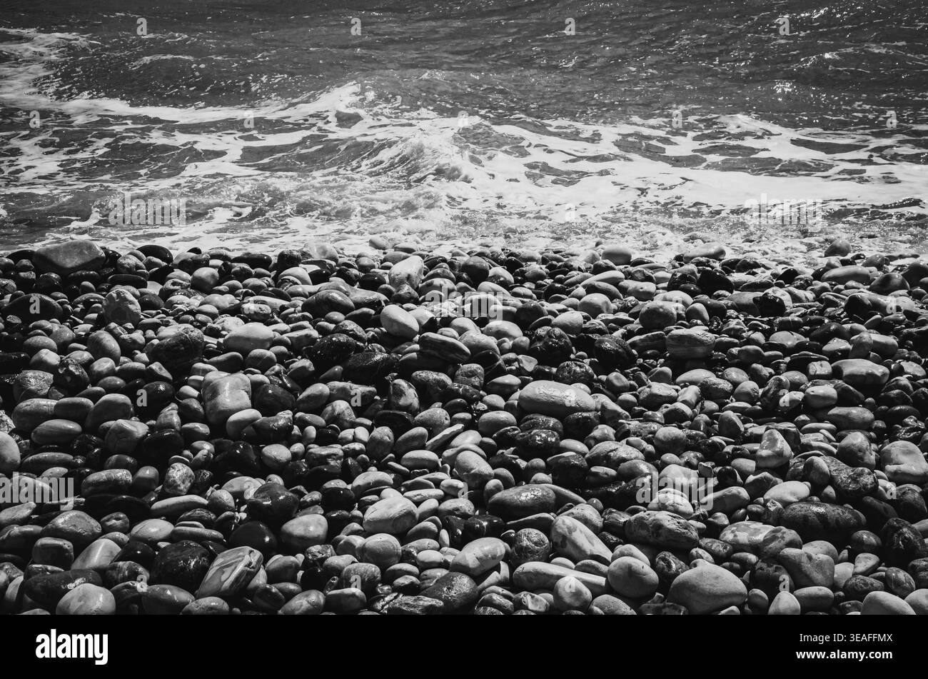 Rocky Seashore mit Wellen in Schwarz und weiß Stockfoto