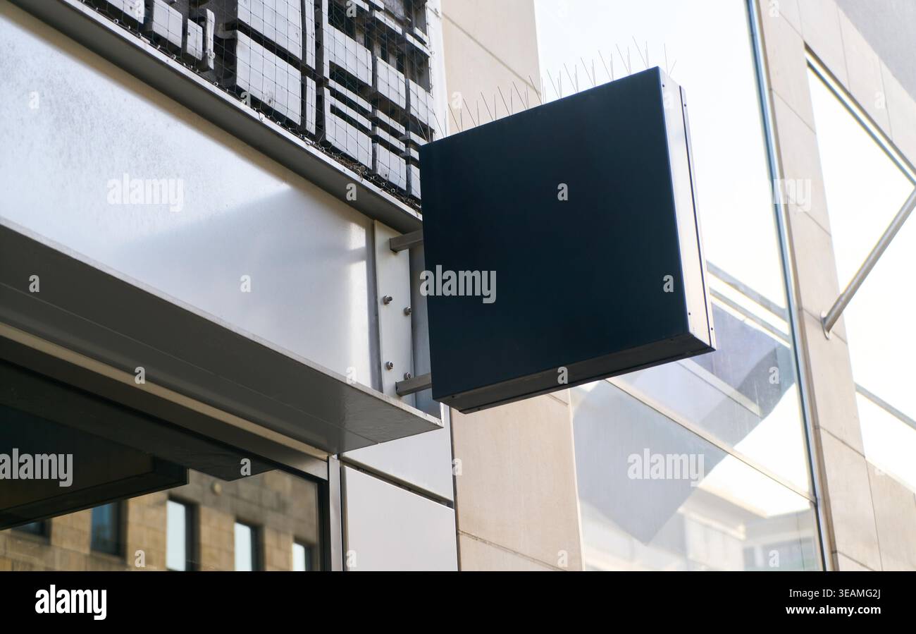 Bei Mockup-Vorlagen für Einzelhandelsflächen wird ein leeres Ladenschild für die Werbung an einem Außenbereich eines Gebäudes in einem städtischen Umfeld angebracht, das gewerbliche Leasing- und Werbemock-ups für den Außenbereich enthält. Stockfoto