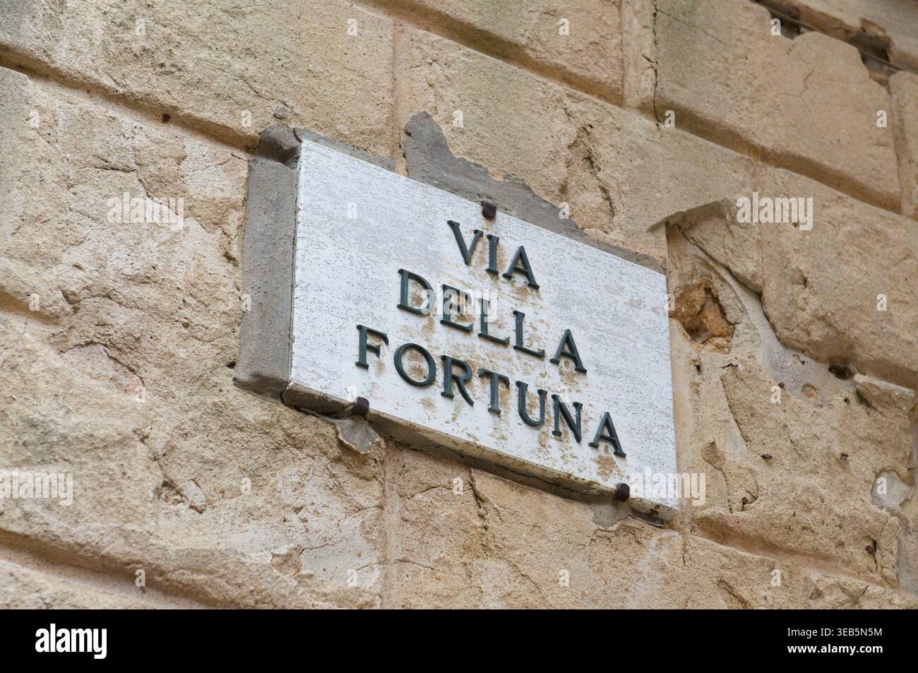 Marmor Straßenschild der Via della fortuna (Straße des Glücks), auf einer Fassade des Gebäudes in Pienza, Toskana Stockfoto