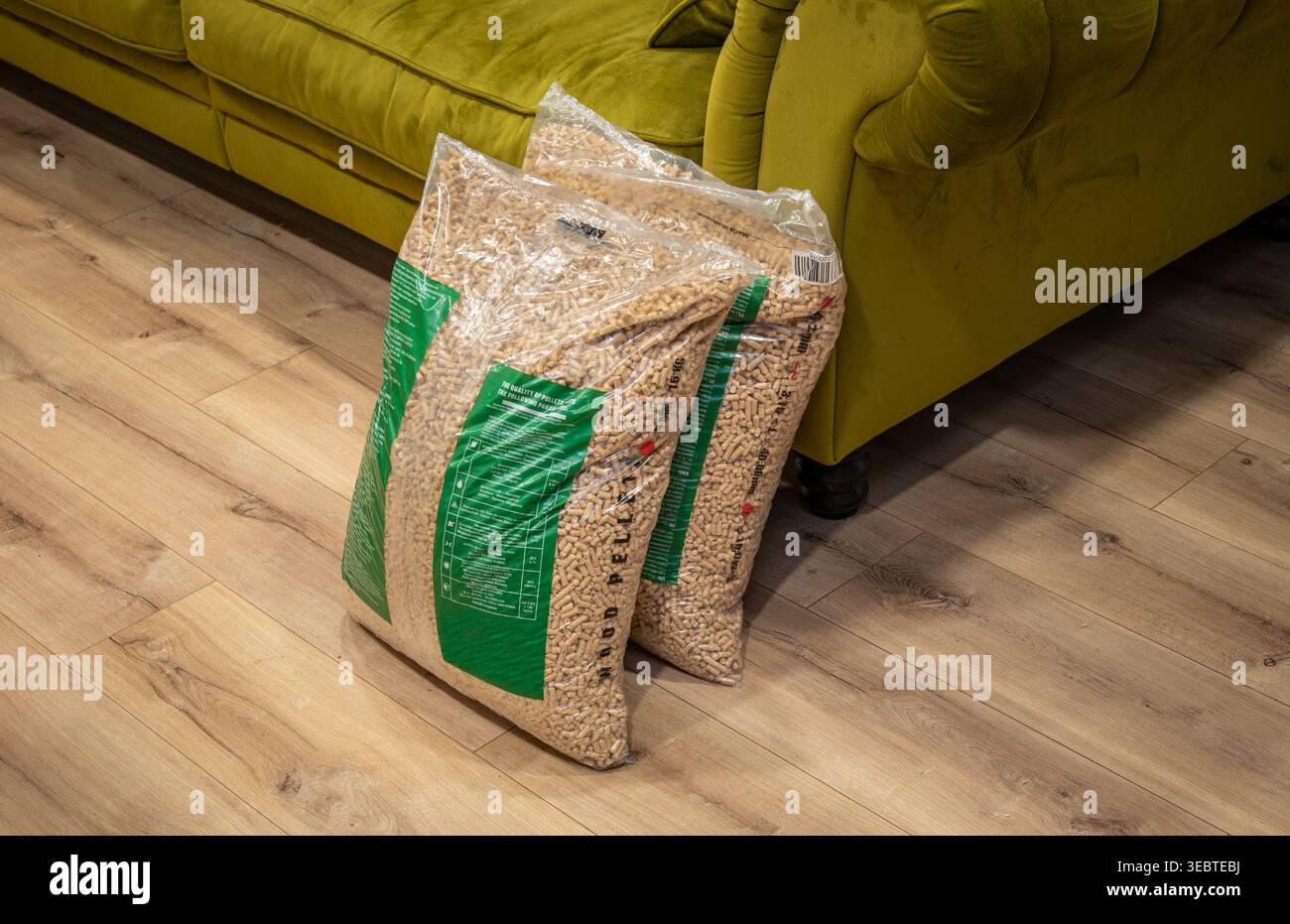 Lagerung Von Holzpellets. Gemütliches Ambiente Im Innenbereich Mit Ordentlich Angeordneten Pellettüten Neben Sofa Und Warmer Beleuchtung Stockfoto