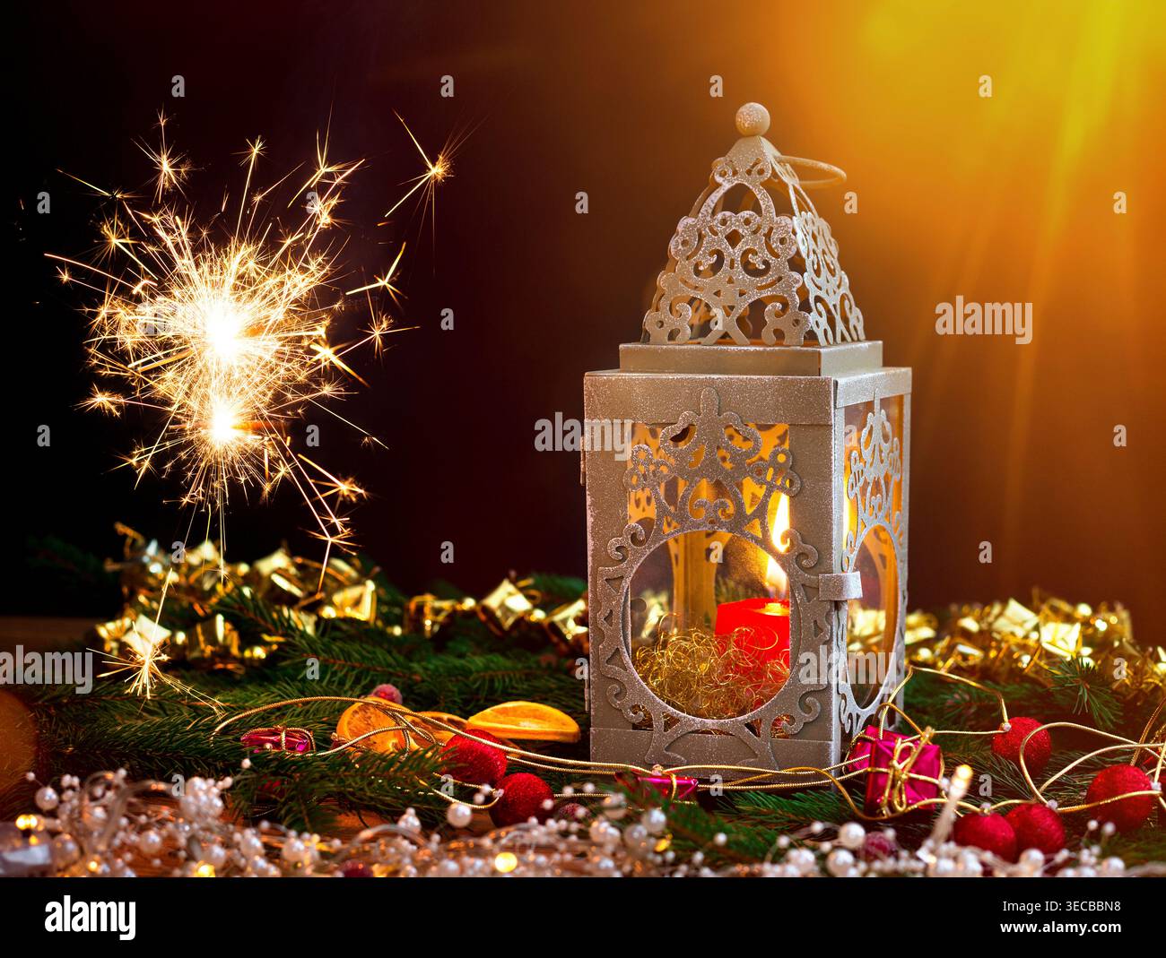 Weihnachtsdekoration mit leuchtendem Glitzer, Kerzen, einer Laterne, Tannenzweigen, Kegeln und getrockneten Orangenscheiben, Komposition Stockfoto