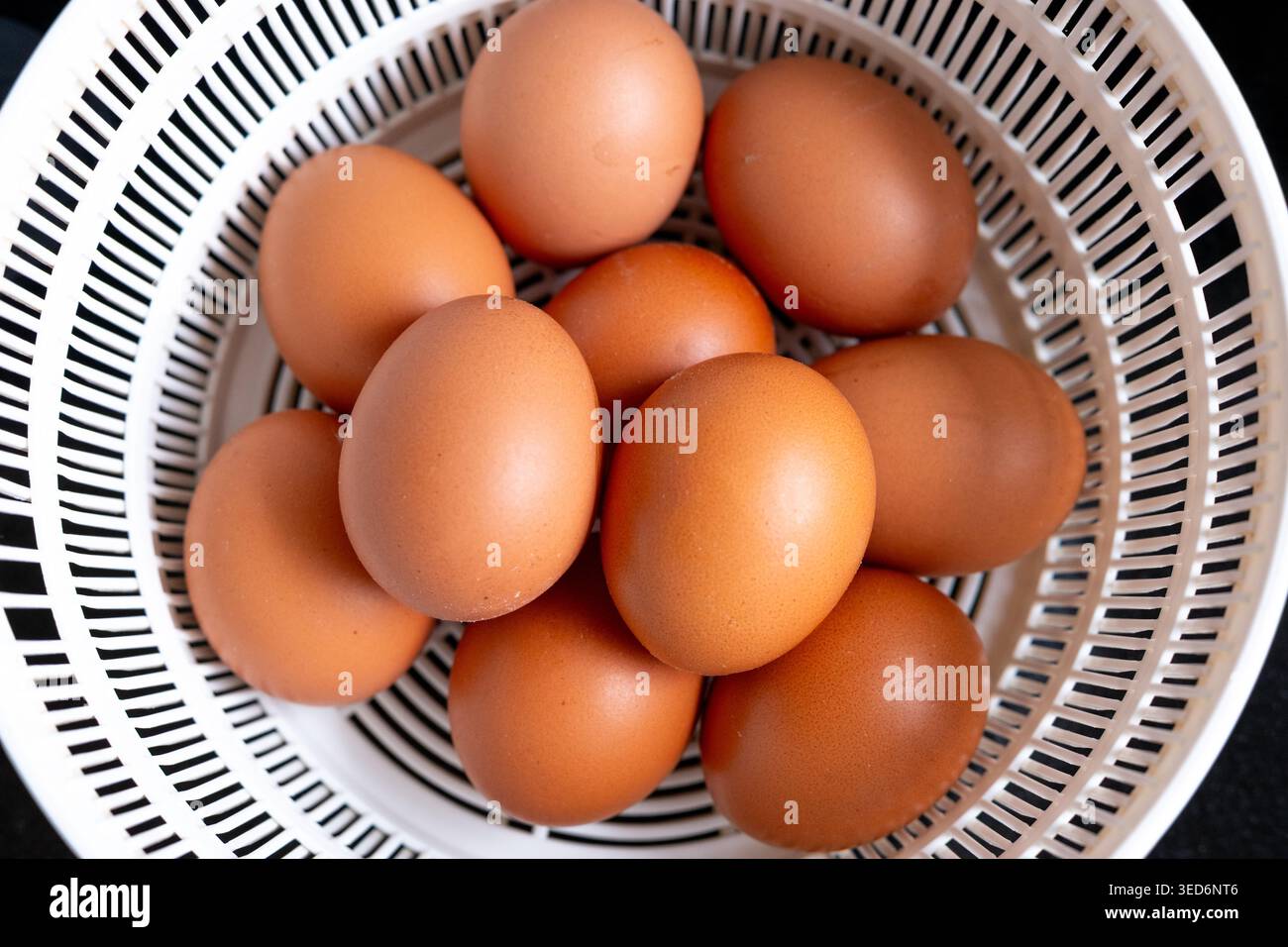 Blick von oben auf frische braune Eier, die in einem Korb angeordnet sind. Natürliches Bauernhof-Food-Konzept geeignet für Kochen, Bio-Produkte, gesunde Ernährung und Landwirtschaft. Stockfoto