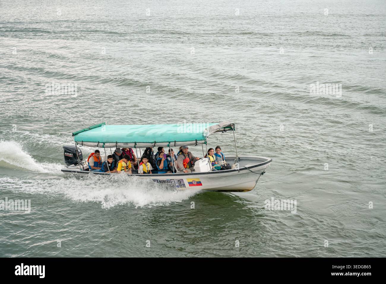 Guatape, kolumbien - enero 14, 2026 abwechslungsreiche, generationsübergreifende Gruppe in Schwimmwesten auf einem rasanten Motorboot, die einen sonnigen Tagesausflug genießen und wach werden Stockfoto