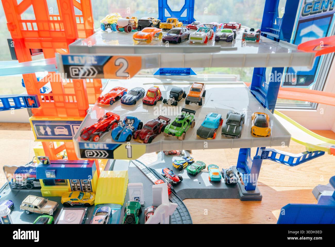 Spielzeugparkplatz mit vielen Miniaturautos. Kindersammlung und Spielkonzept. Spielzeuggarage gefüllt mit Miniaturautos. Unterhaltsame und kreative Aktivitäten für Stockfoto