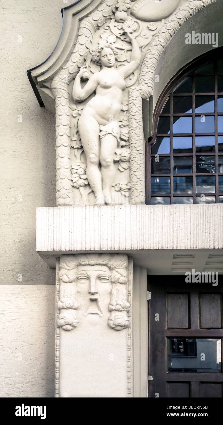 Kunstvoll verzierte Eingangstür mit plastischem Relief im Jugendstilstil in Bogenhausen in München, erbaut um 1910. Stockfoto