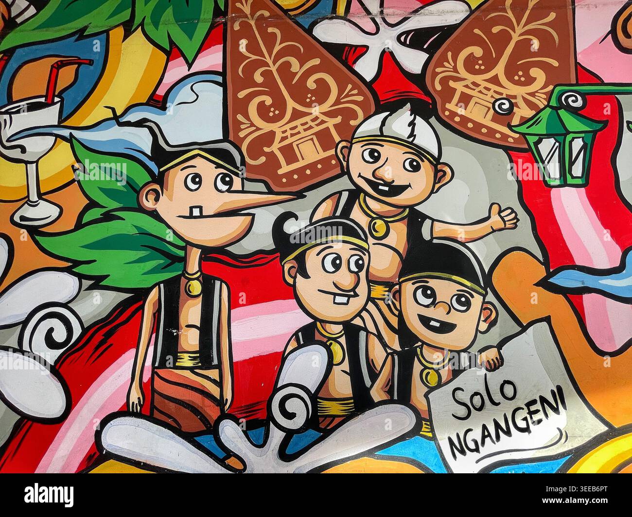 Farbenfrohes Graffiti-Wandgemälde mit fröhlichen Zeichentrickfiguren in traditioneller javanischer Kleidung, die die lokale Kultur und Identität bei einem Solo-9. Mai 2026 zelebrieren Stockfoto