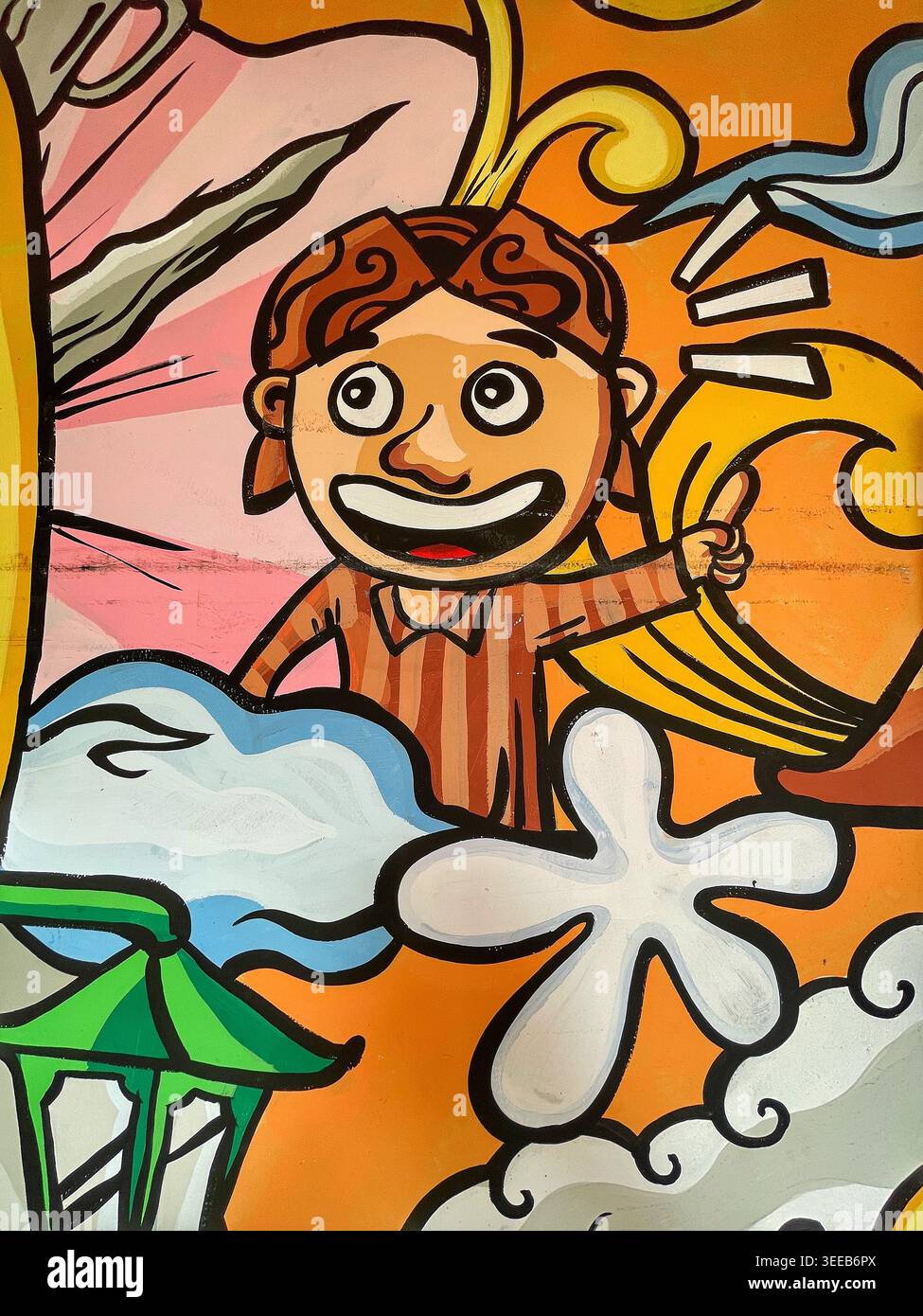 Farbenfrohes Graffiti-Wandgemälde mit fröhlichen Zeichentrickfiguren in traditioneller javanischer Kleidung, die die lokale Kultur und Identität bei einem Solo-9. Mai 2026 zelebrieren Stockfoto