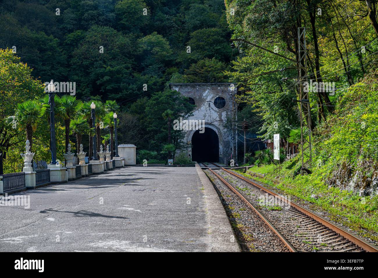 Der alte Eisenbahntunnel steht am Ende der Bahnstrecke in New Marathon, umgeben von grünen Bäumen und einem ruhigen Pfad Stockfoto