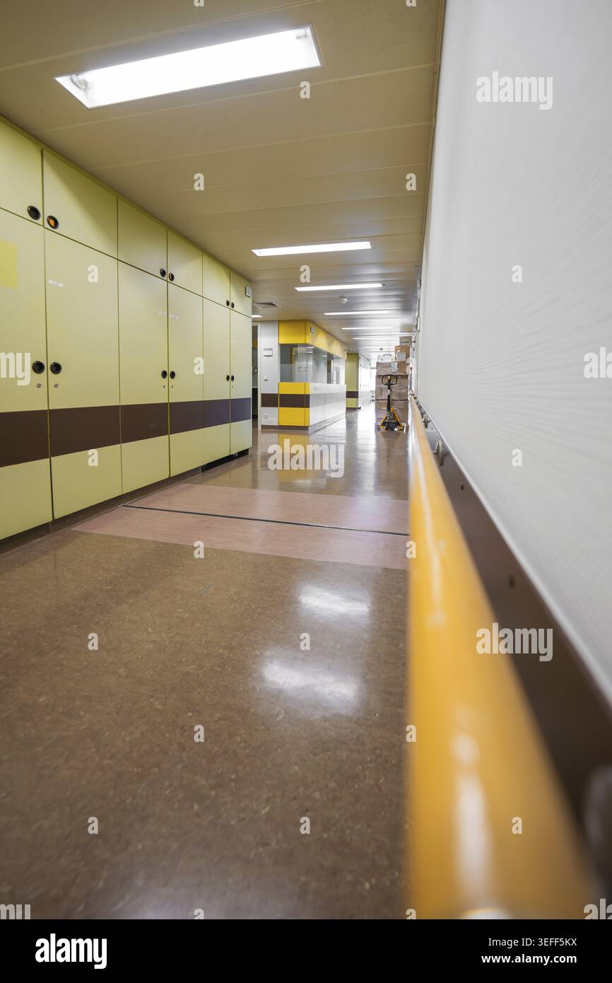 Perspektive eines gelb-braunen Krankenhauskorridors mit linearem Design, Nagold Hospital des Klinikverbunds Suedwest, Bezirk Calw, Deutschland Stockfoto