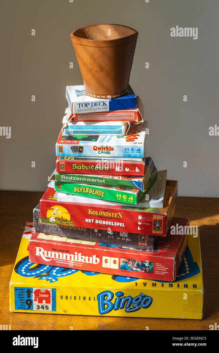 EDE, Niederlande, 18.05.2026, Classic Board Game Collection gestapelt auf Holztisch, nostalgisches Indoor-Freizeitkonzept Stockfoto