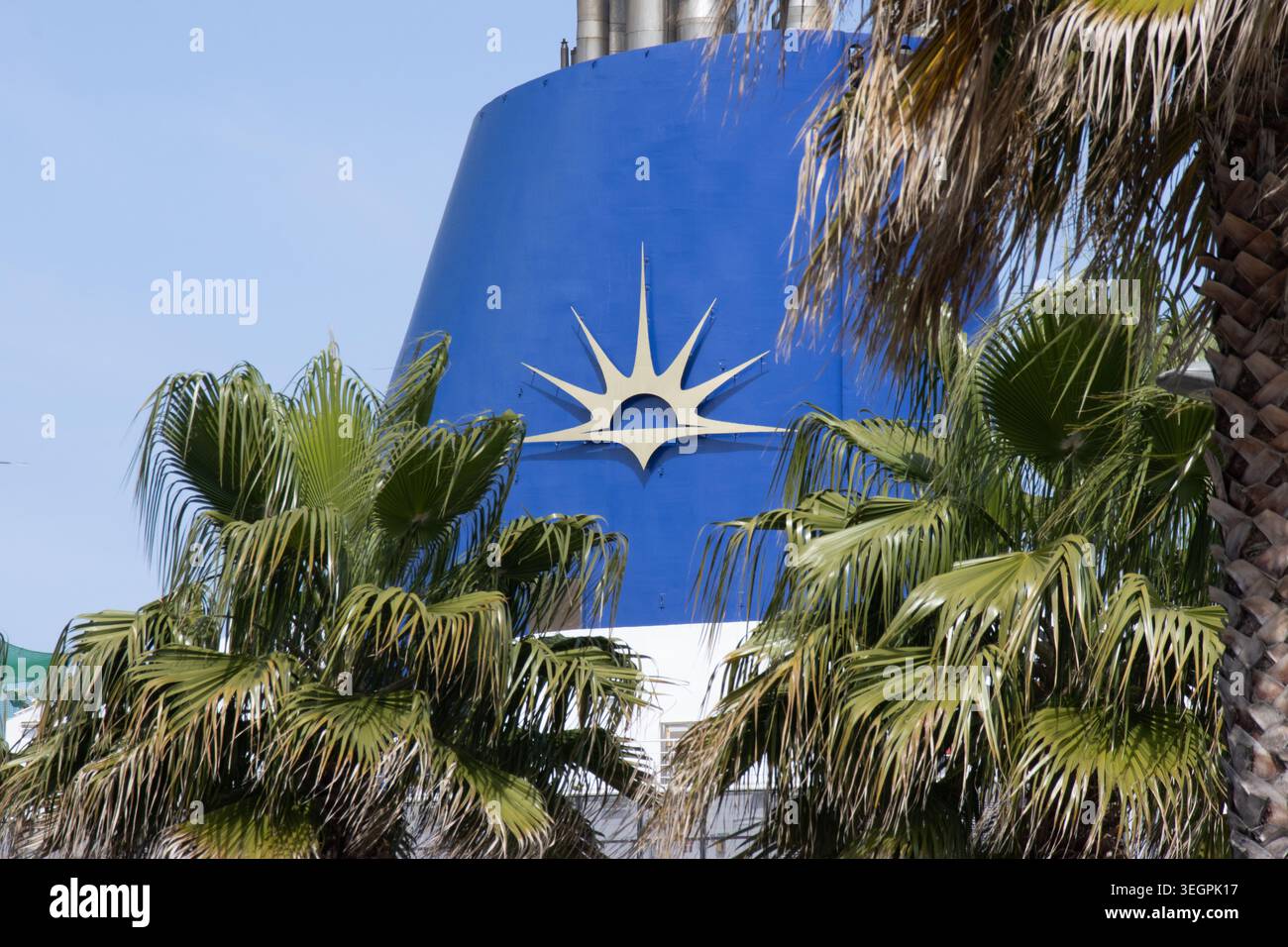 Goldenes Logo von P&O Cruises auf einem blauen Schiffstrichter, eingerahmt von Palmen. Stockfoto