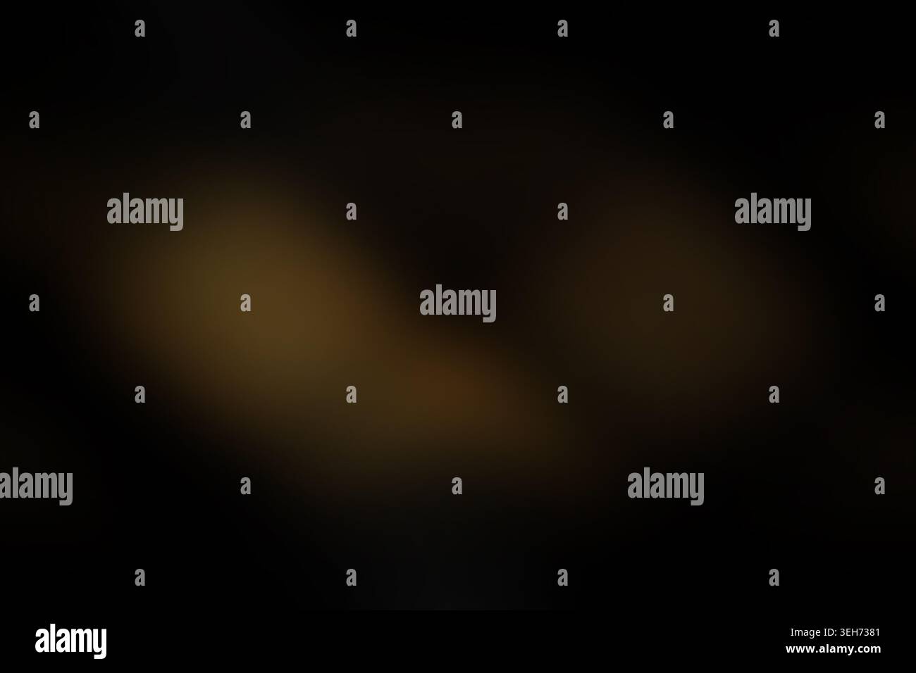 Ein dunkler, stimmungsvoller abstrakter Hintergrund mit subtilen, sanften goldenen Lichtflecken, die aus tiefschwarzen Schatten hervorgehen und eine geheimnisvolle Atmosphäre schaffen Stockfoto