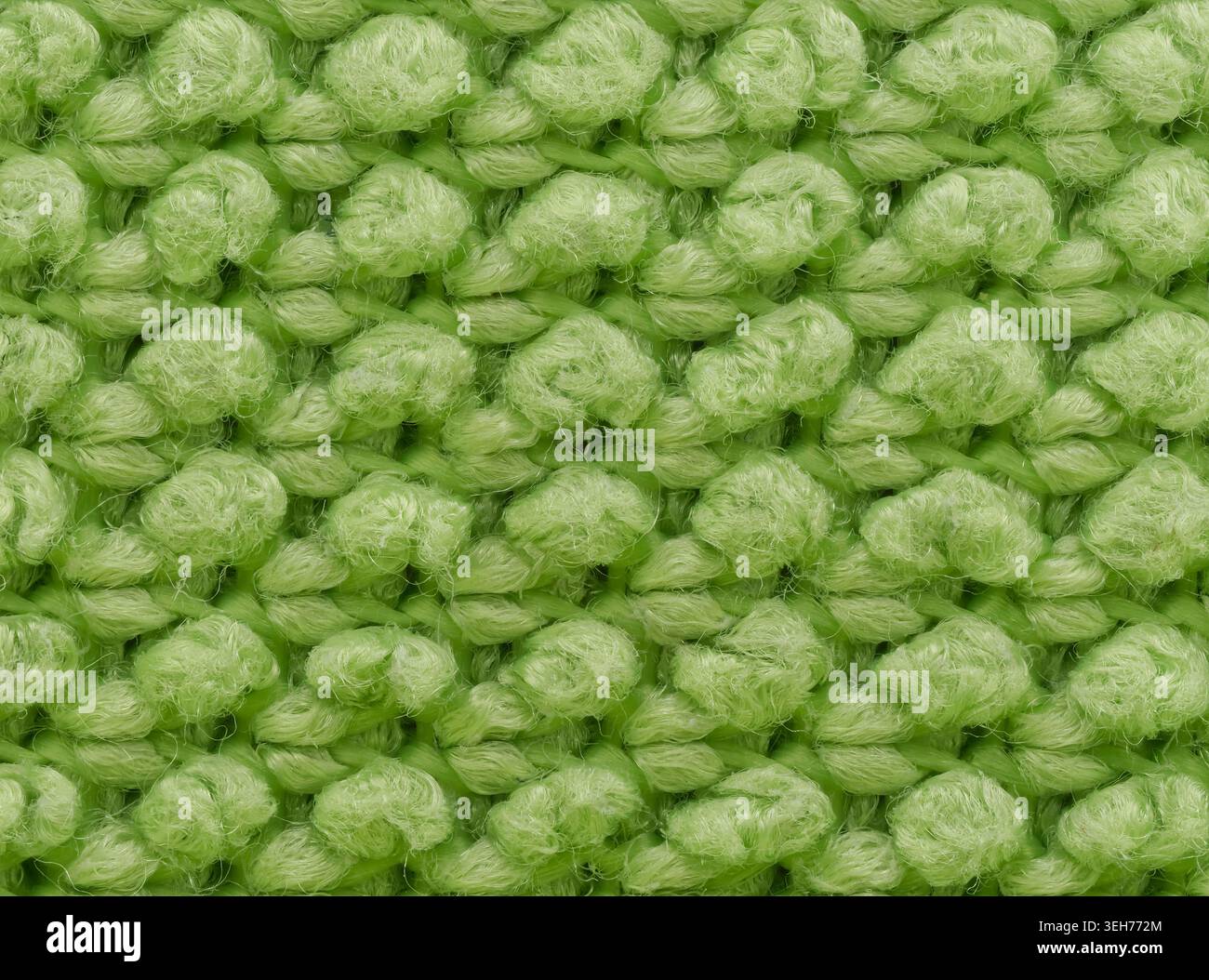 Extreme Makrofotografie einer grünen Mikrofasertextur mit einzelnen Faserschleifen Stockfoto