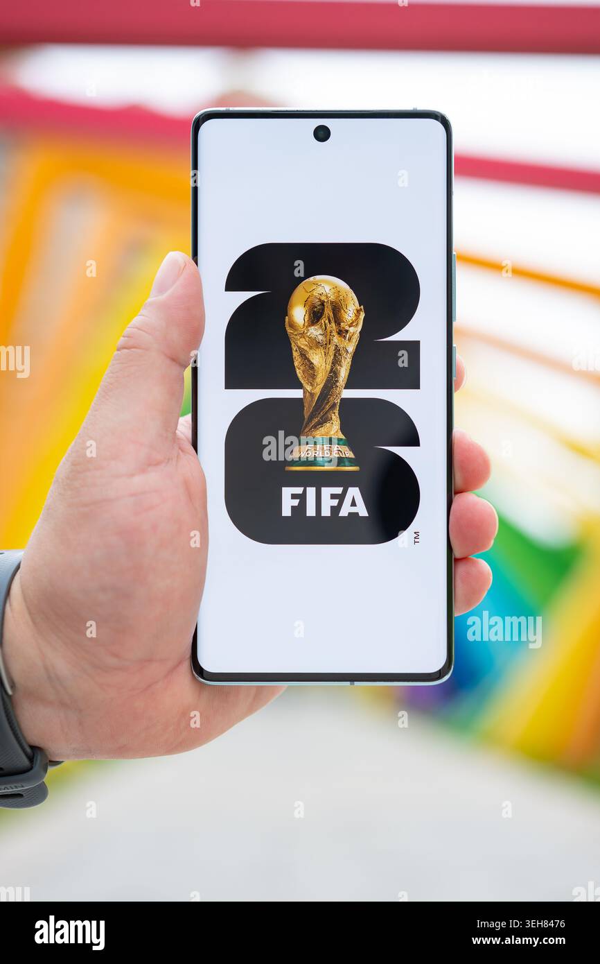 Zhongshan Guangdong China-23. Mai 2026: Hand hält ein Handy mit World Cup 2026 Logo im Freien in vertikaler Compositon. Stockfoto
