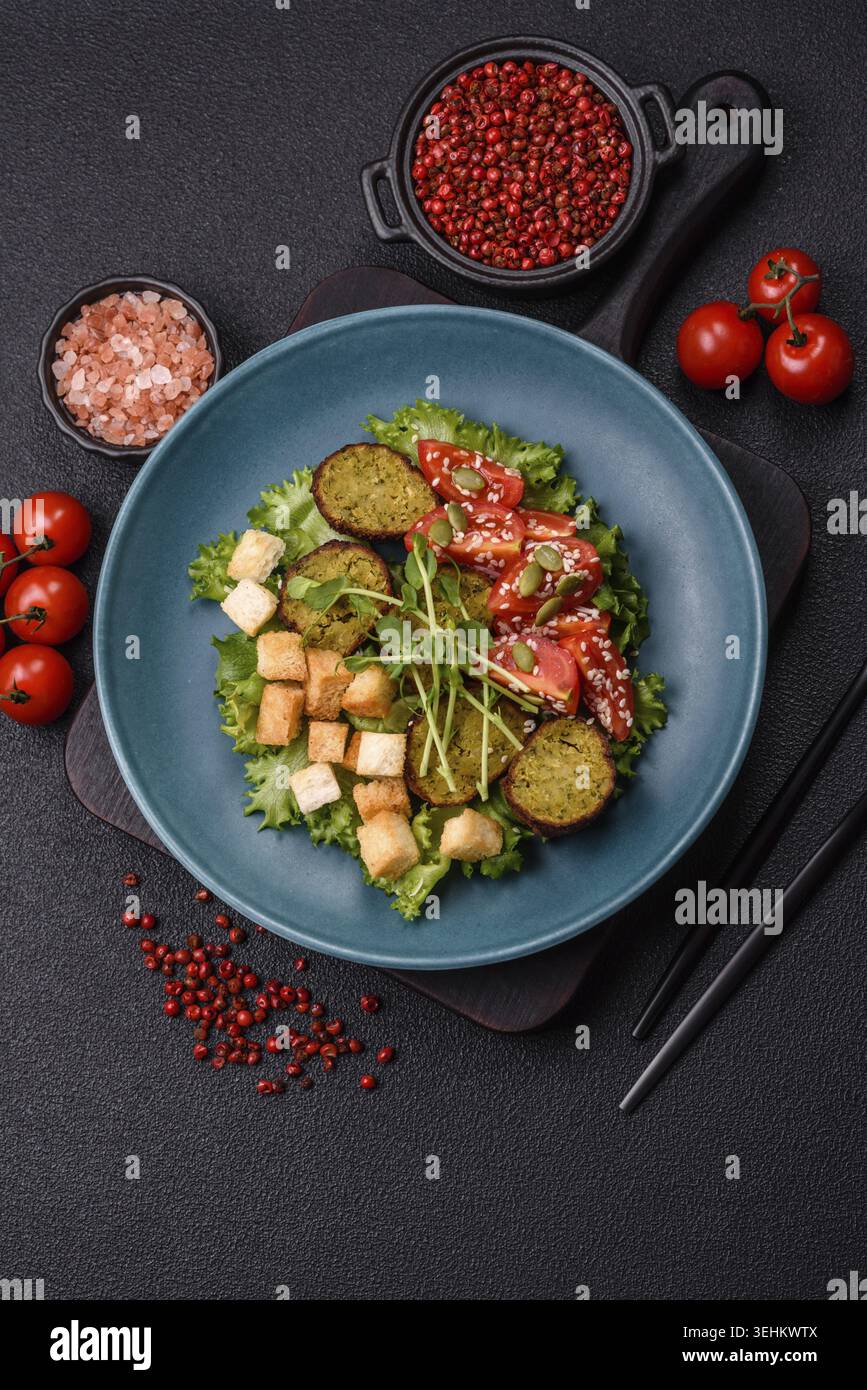Essen, deftige köstliche frittierte Falafel aus Kichererbsen, Kümmel, Hummus mit Salz und Gewürzen auf dunklem Betonhintergrund Stockfoto