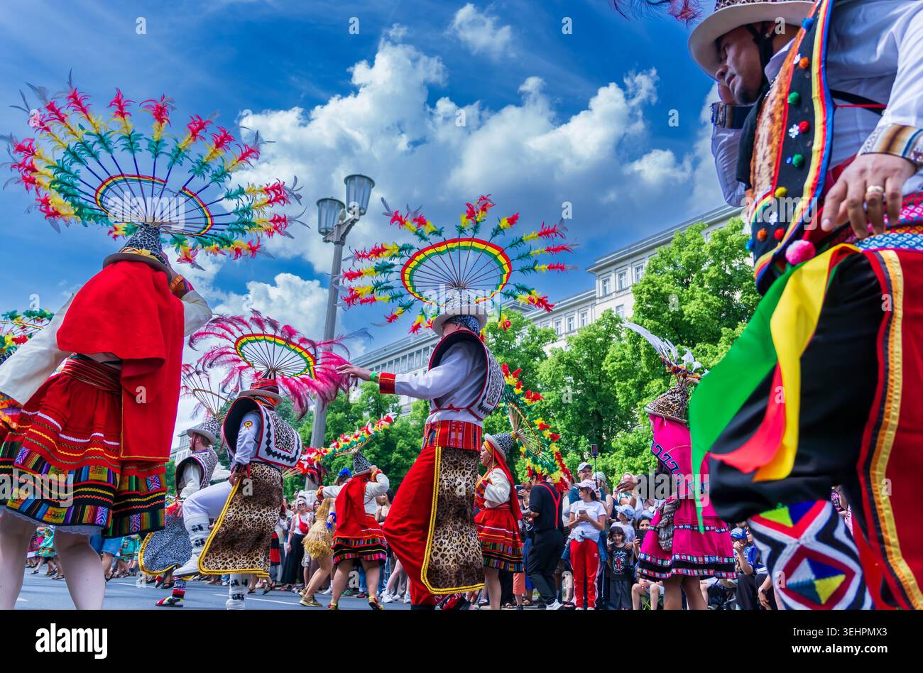 Berlin, Deutschland - 24. Mai 2026: Anden-Folklore-inspirierte Künstler mit kreisförmigen Federkopfschmuck tanzen während des Karnevals der Kulturen. Stockfoto