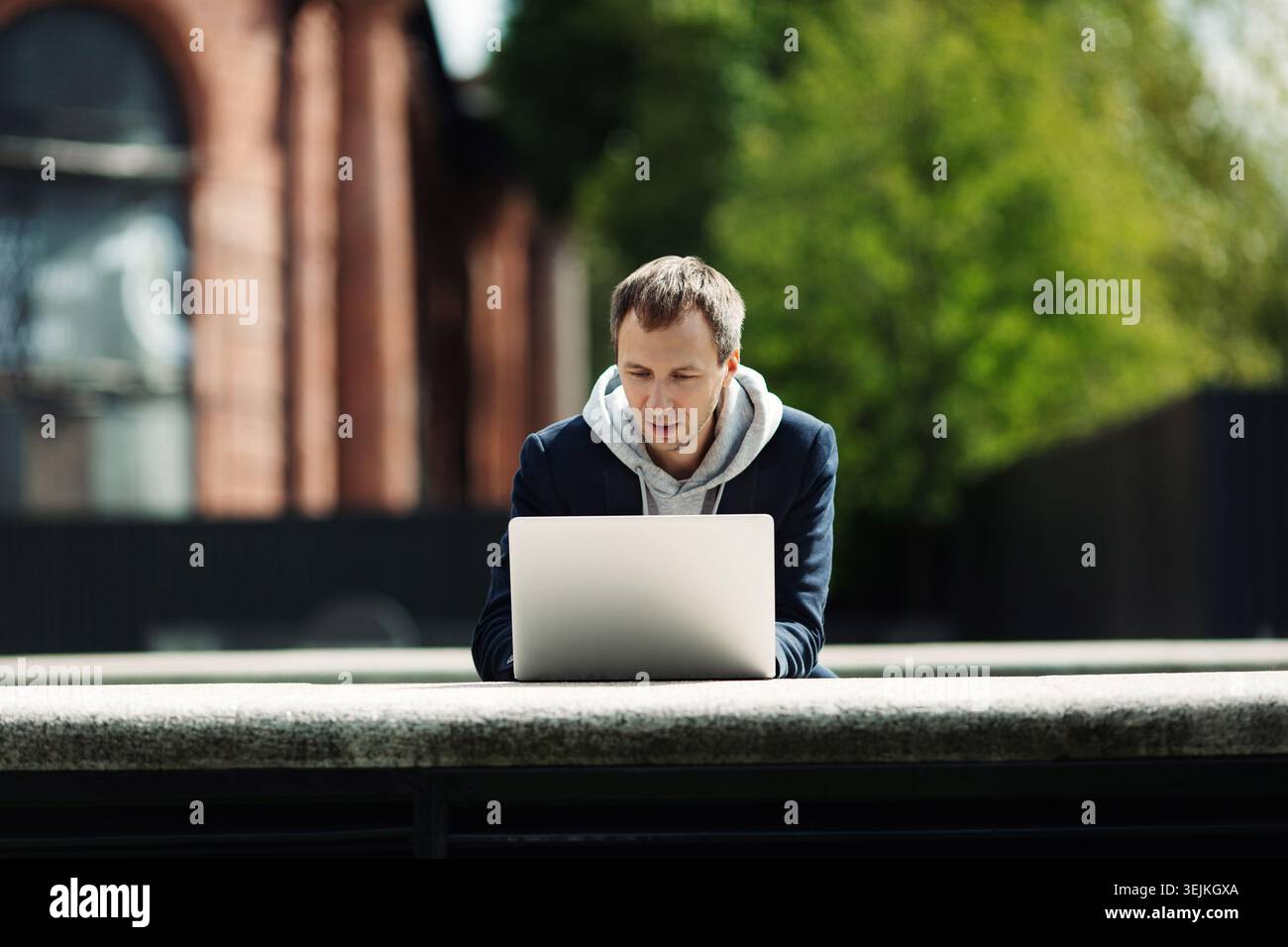 Gelegenheitsunternehmer, der an einem Laptop im Freien an einer Startup-Idee oder einer Projektentwicklungsstrategie arbeitet Stockfoto