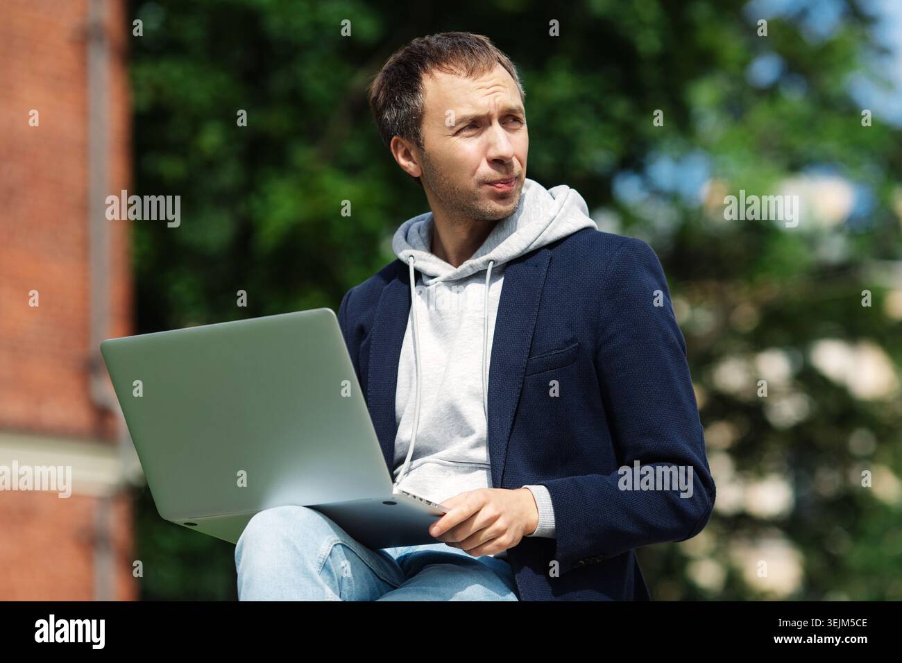 Legere Geschäftsleute mit Laptop-pc nutzen die drahtlose Internetverbindung, um im Park im Freien zu arbeiten Stockfoto