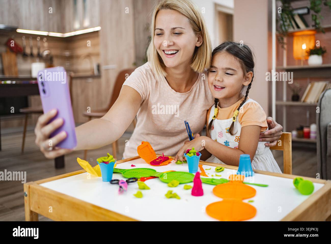 Mutter und Tochter genießen einen spielerischen Moment während sie ein Selfie machen Stockfoto