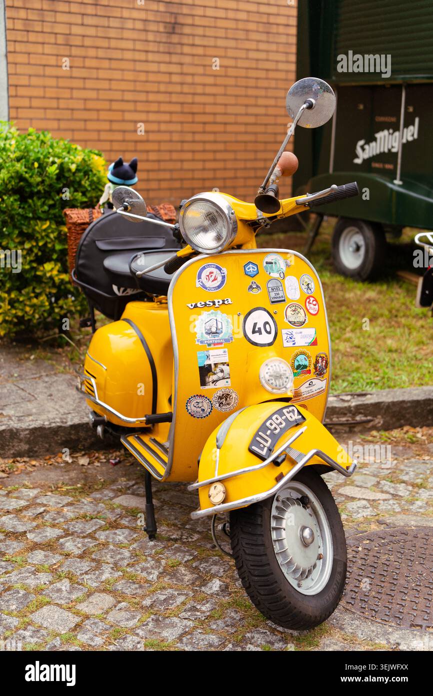 Maia - Porto - Portugal , 30. Mai 2026: Gelber vespa-Roller mit zahlreichen Reise- und Rallye-Aufklebern auf der Karosserie. Stockfoto