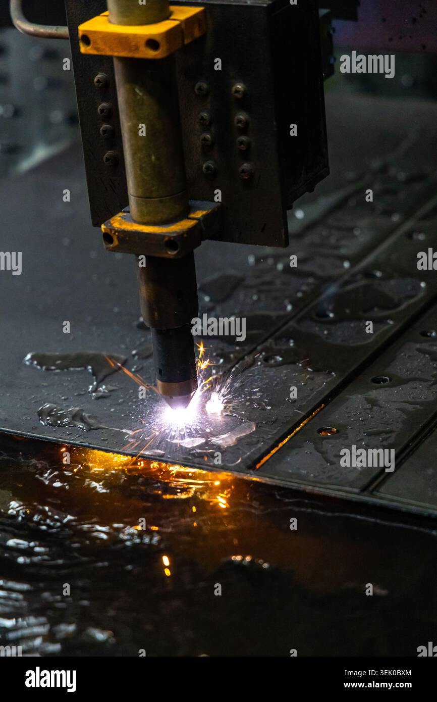 Plasmaschneidemaschine, die Metallbleche mit Funken im Werk verarbeitet Stockfoto