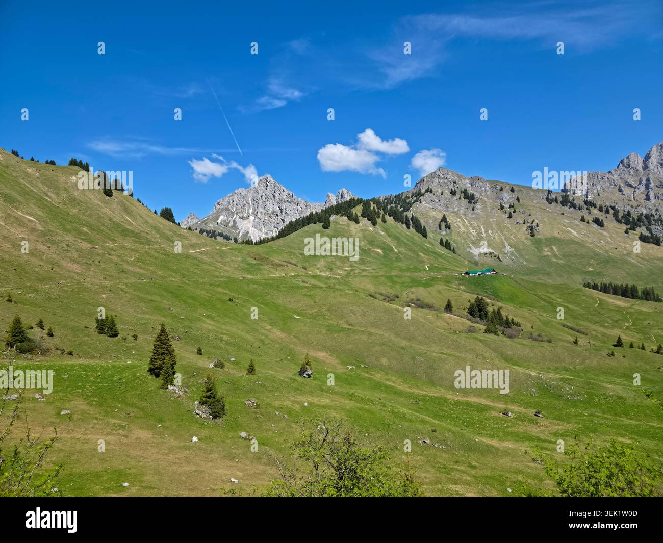 Österreich, malerischer Bergweg neben verschneiten Alpenfeldern, der die Wanderer in die einladende Hüttenlandschaft am hahnenkamm führt Stockfoto