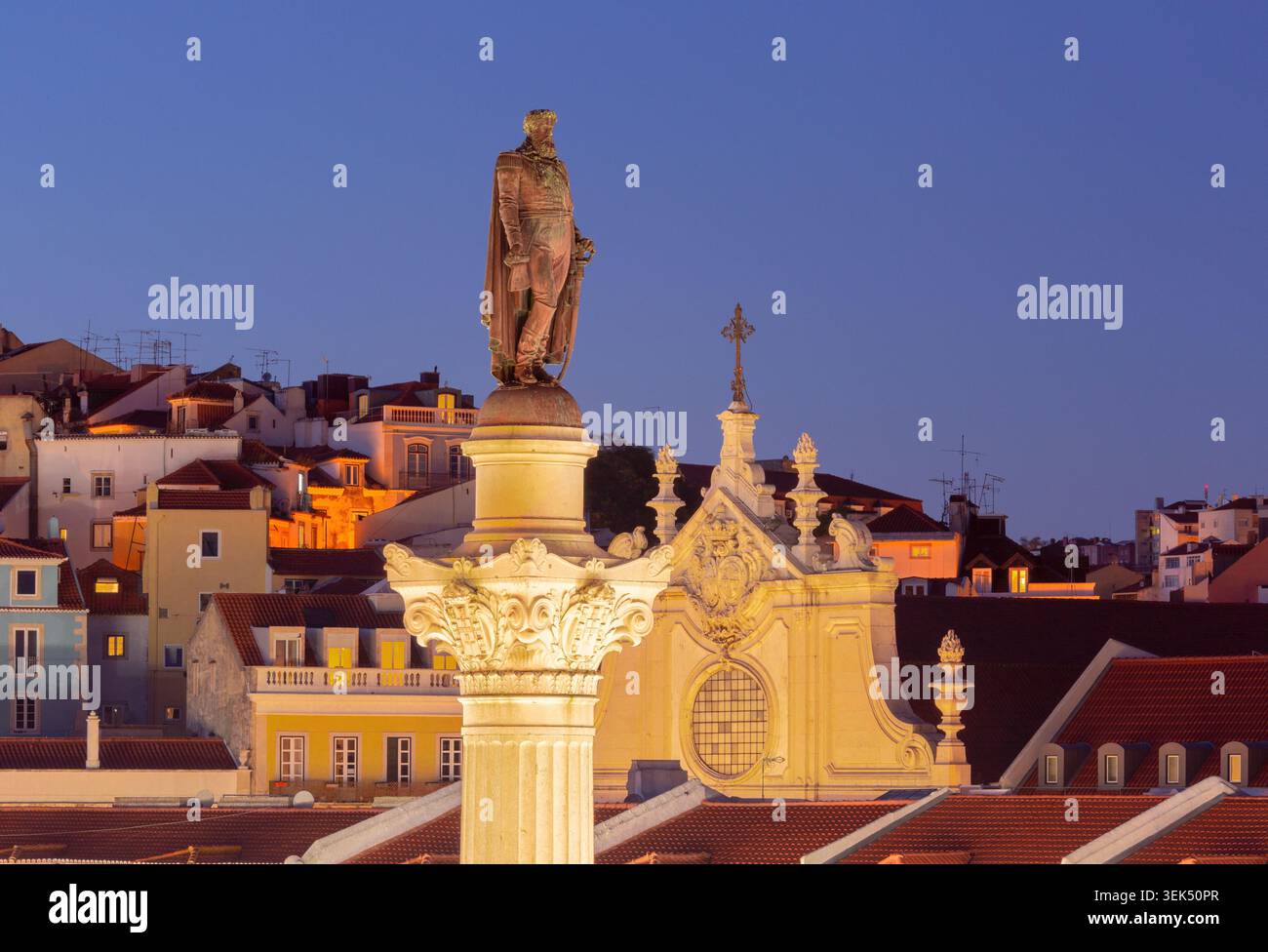 Blick aus der Nähe auf das Pedro IV Monument mit beleuchteter historischer Architektur im Zentrum von Lissabon während der Abenddämmerung. Stockfoto