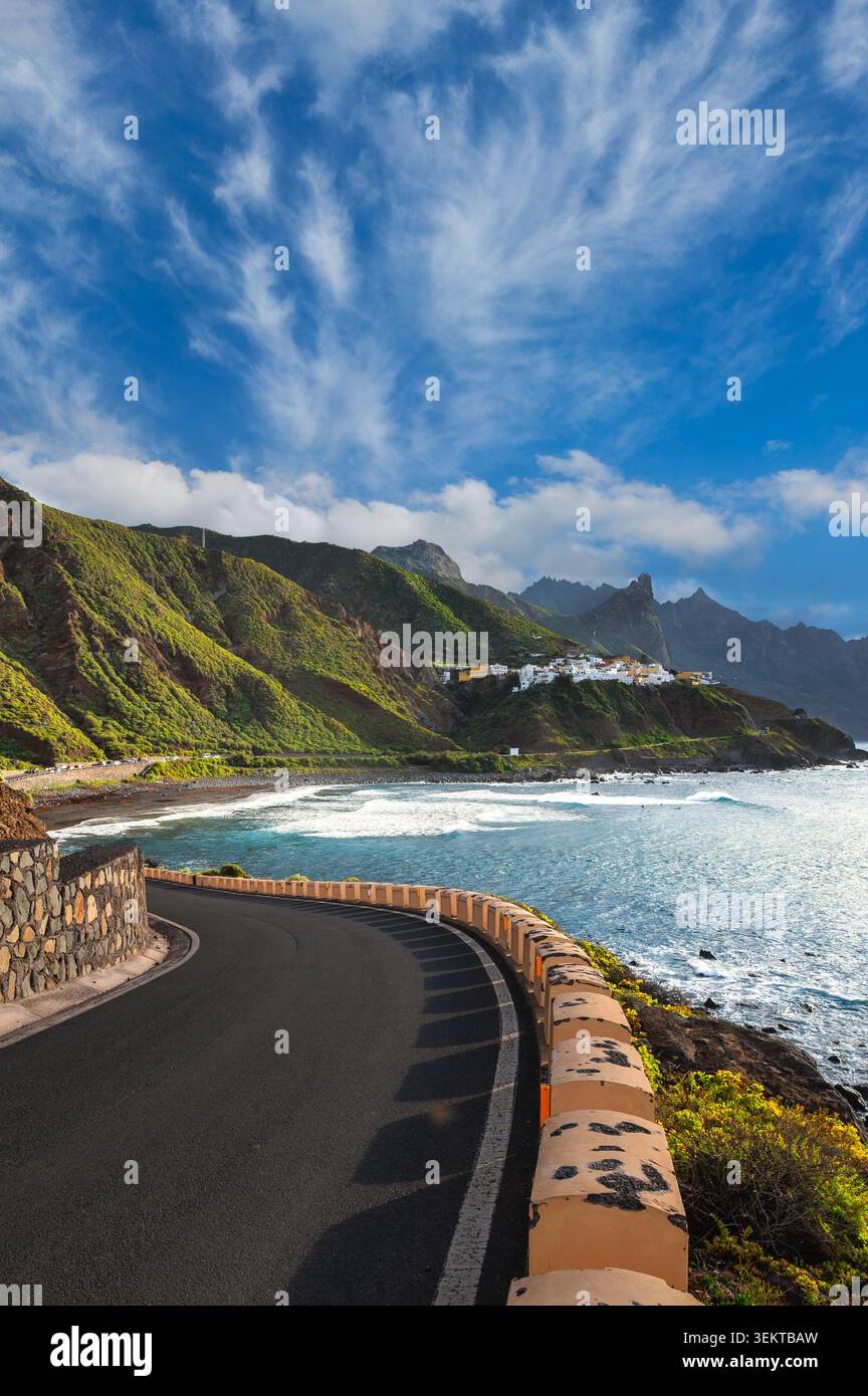 Die gewundene Küstenstraße entlang der Rocky Coast mit dem White Village auf Green Cliffs, Teneriffa, den Kanarischen Inseln, Spanien Stockfoto