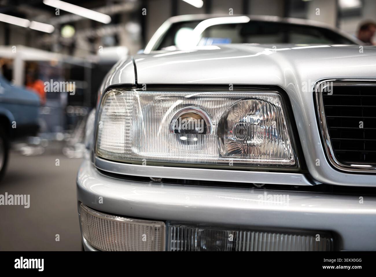 Luzern, Schweiz, 30. Mai 2026. Der klassische Scheinwerfer aus Glas und der unverwechselbare Kühlergrill eines Audi Cabriolets der B4-Generation in Silber sind in den Vordergrund gestellt Stockfoto