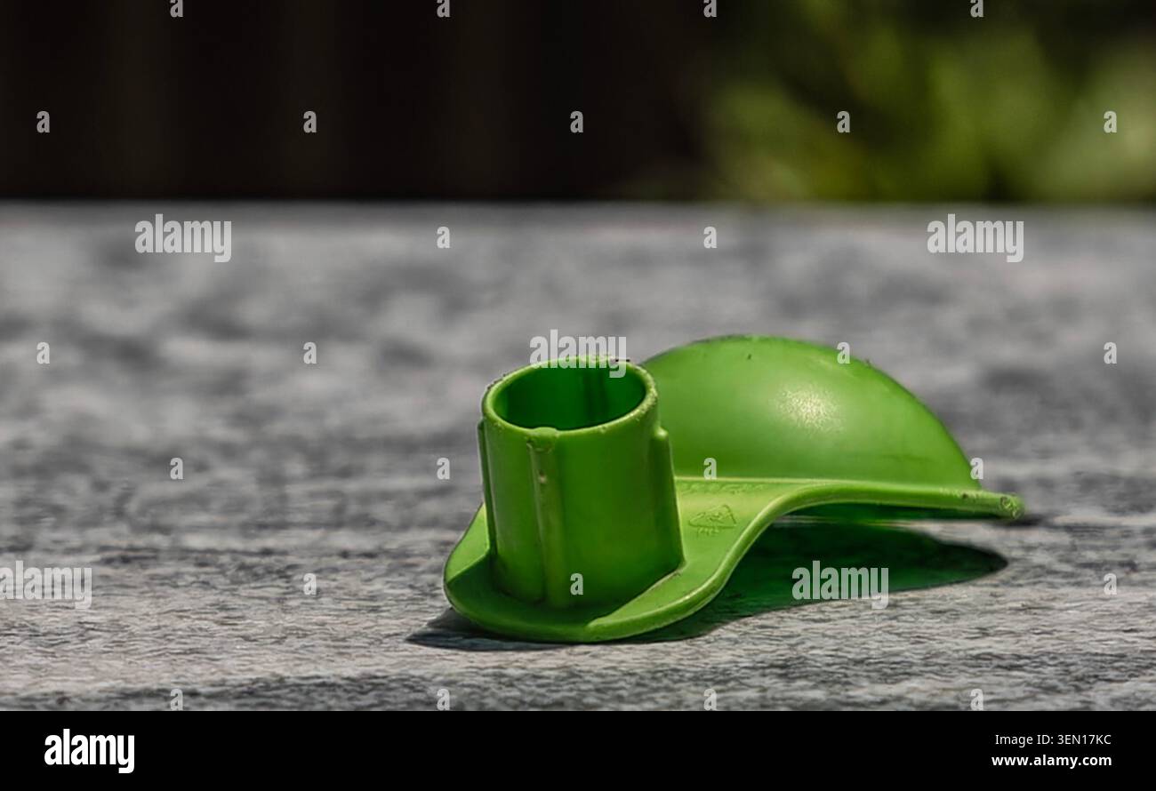 Ein grünes Plastikobjekt auf einer Marmorplatte Stockfoto