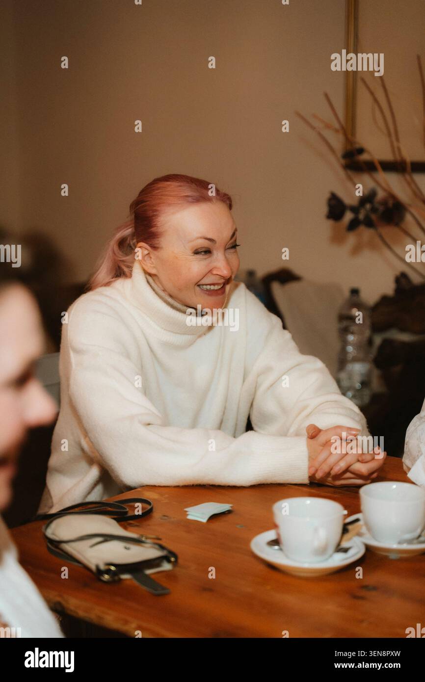 Lebhafte Unterhaltung bei Kaffee mit lächelnden Gesichtern Stockfoto