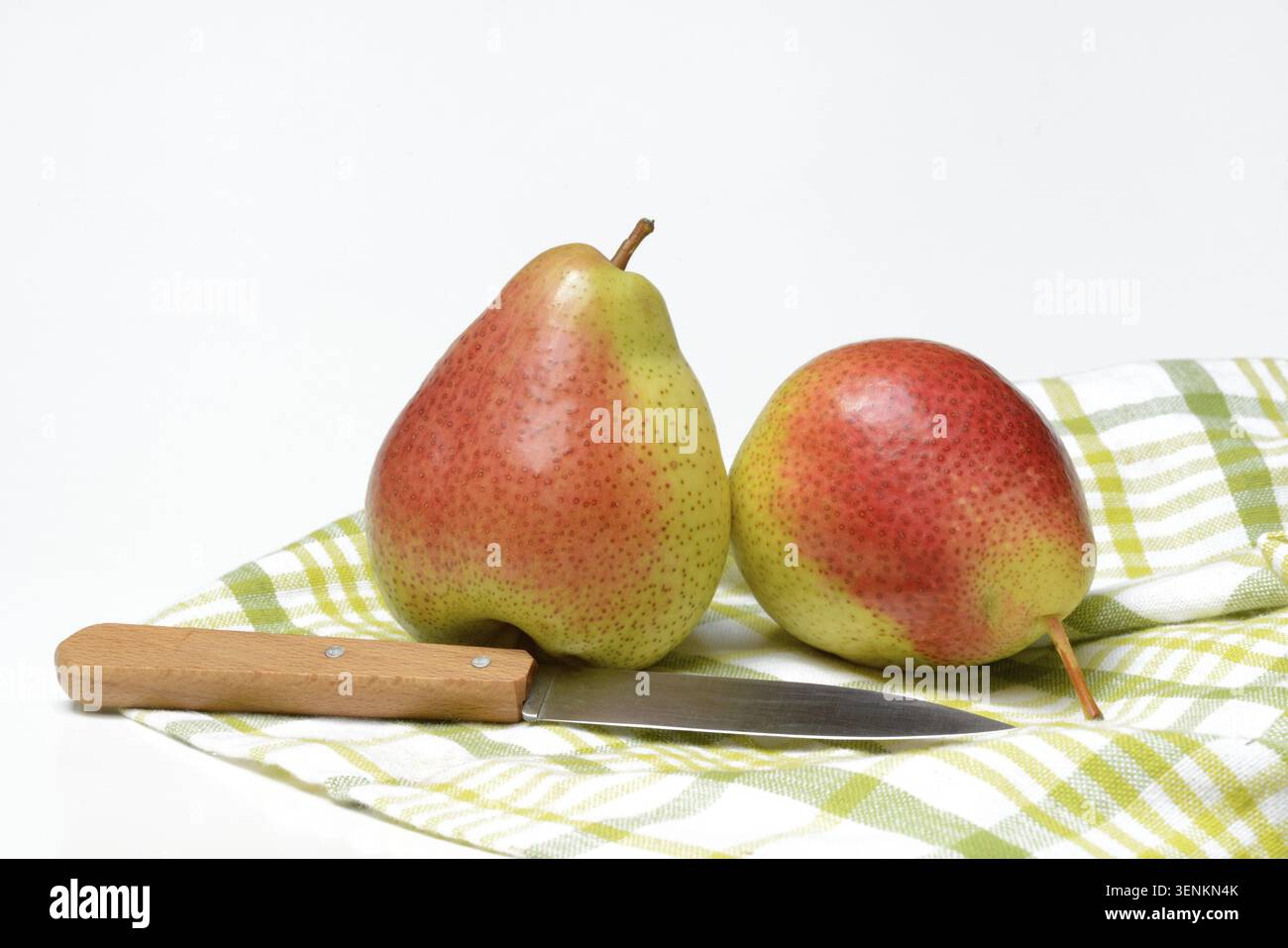 Zwei Birnen auf Tuch mit Küchenmesser Stockfoto