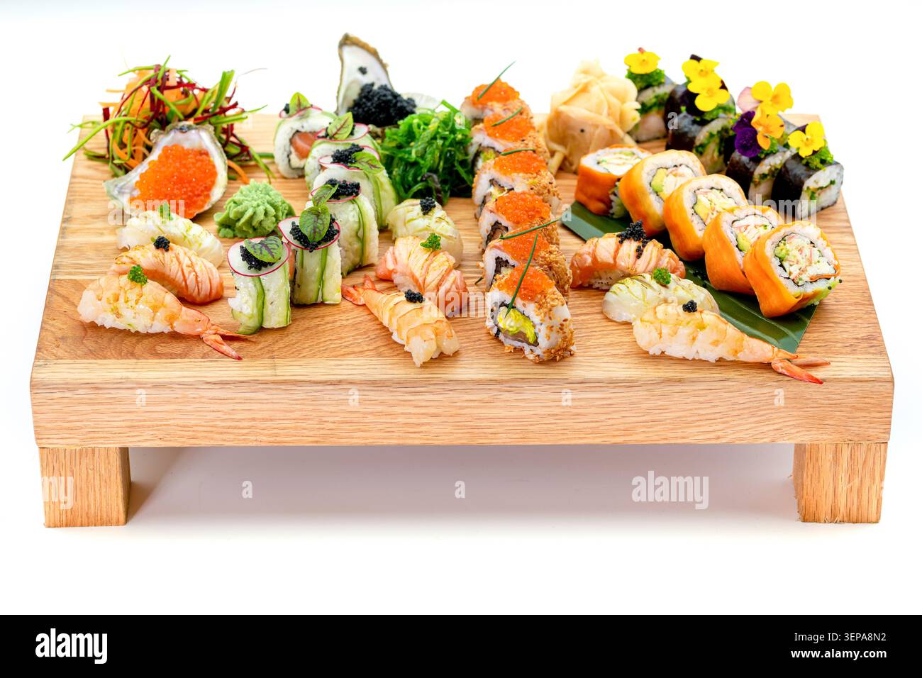 Verschiedene Sushi- und Nigiri-Auswahl auf hölzernem Servierbrett isoliert auf weißem Hintergrund Stockfoto