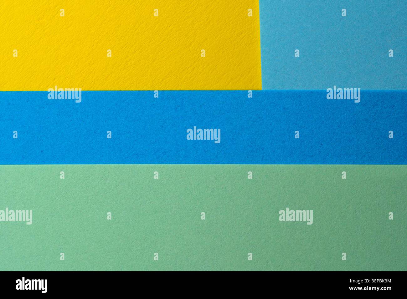 Helle Blätter in Gelb, Blau und Grün bilden ein beeindruckendes Design. Stockfoto
