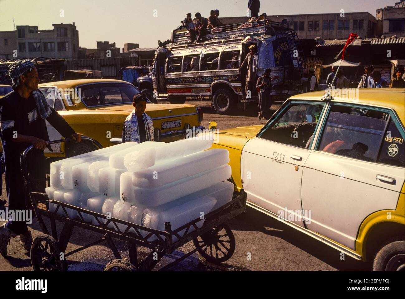 Eisverkäufer mit großen Eisblöcken in der geschäftigen Marktgegend, Kabul Afghanistan, August 1992 Stockfoto