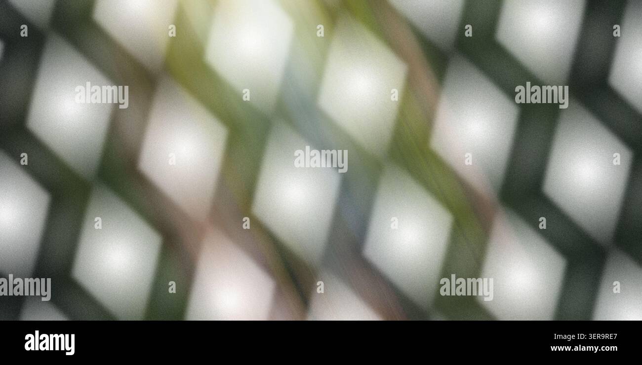 Ein abstrakter Hintergrund mit einem sich wiederholenden Muster aus leuchtenden, weichen Diamantformen mit dezenten grünen und gelben Lichtstreifen. Stockfoto