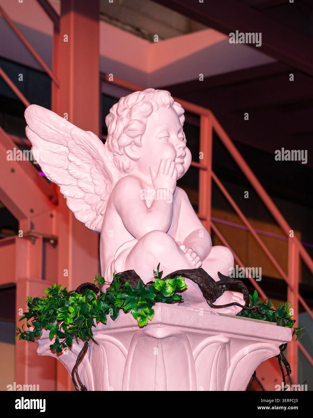 Pinkfarbene Engelsstatue im warmen Abendlicht Stockfoto