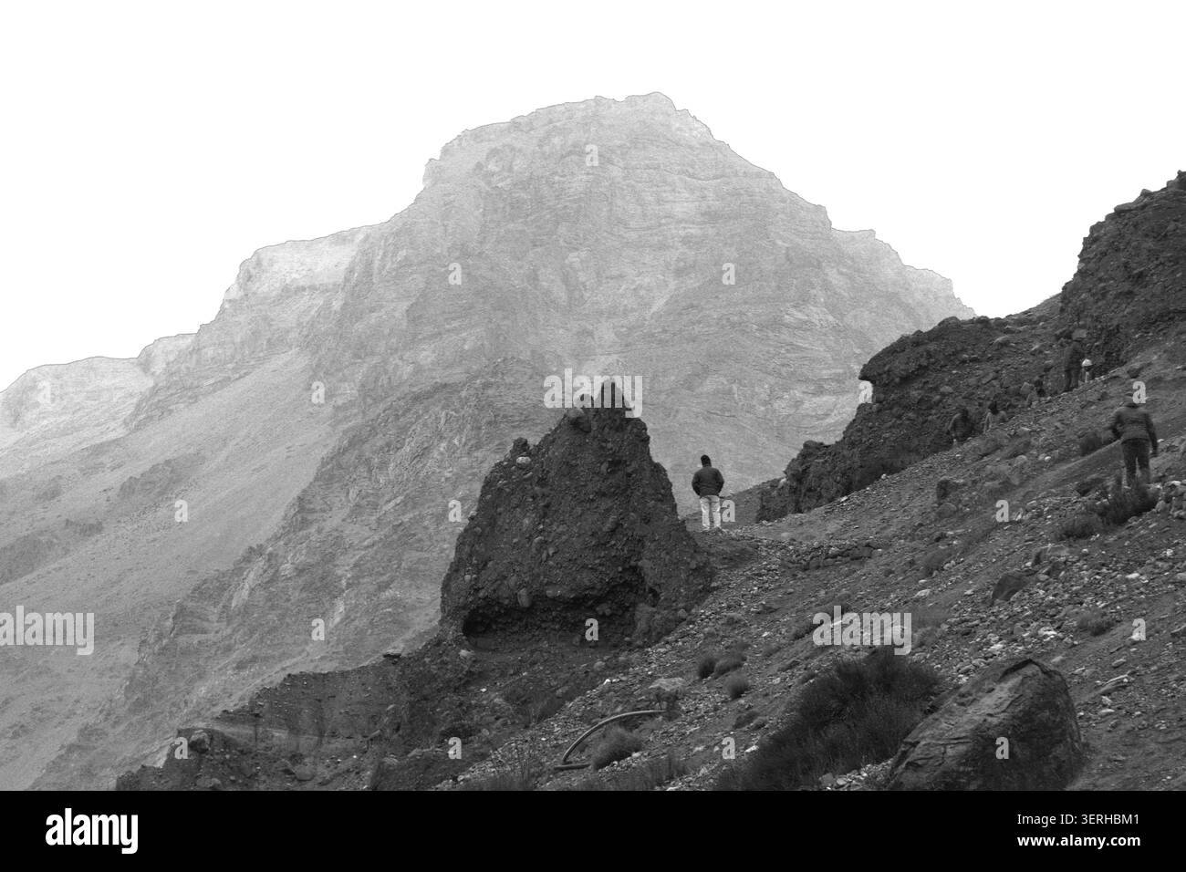 Touristen wandern auf einem felsigen Bergpfad in der Höhenlandschaft des Spiti Valley, Himachal Pradesh, Indien. Stockfoto