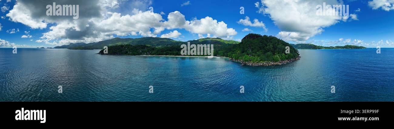 Panoramische Drohnenansicht der üppigen Küste von Mahé von Anse Louis bis Anse La Mouche, Seychellen, mit lebendigen tropischen Bergen und dem blauen Indischen Ozean Stockfoto