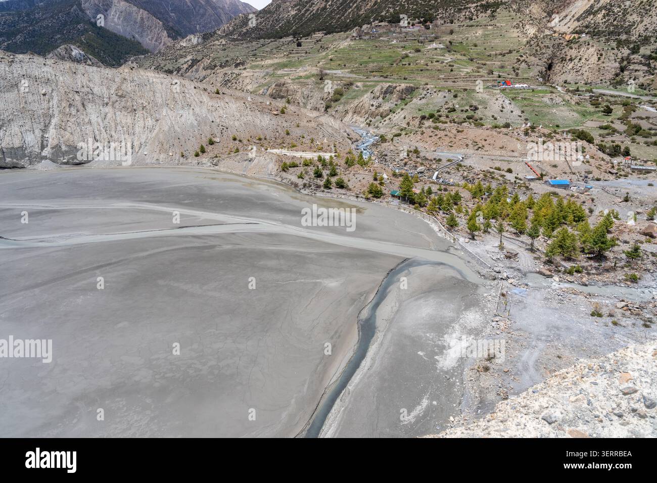 Getrockneter Gangapurna-See nahe Manang auf dem Annapurna Circuit in Nepal mit freigelegtem Sediment, das wechselnde Gletscherm Wassermengen offenbart Stockfoto
